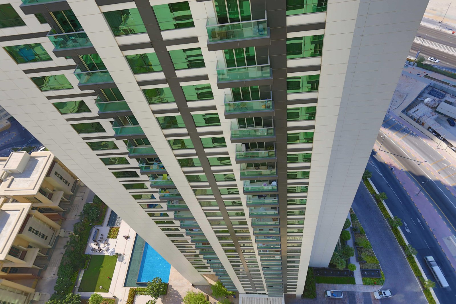 Swimming pool area and landscaped gardens at Burooj Views, Marina Square, Abu Dhabi, featuring premium outdoor amenities and luxury lifestyle facilities.